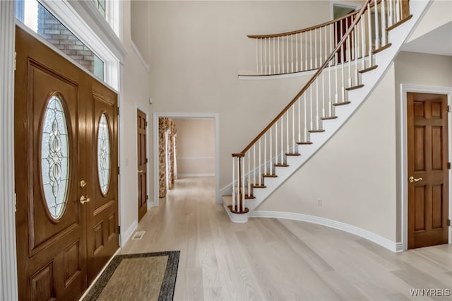 25 Davinci Ct, Amherst, NY 14221 - foyer entrance featuring a towering ceiling, wood finished floors, plenty of natural light, stairway, and baseboards