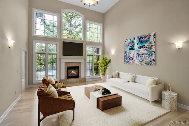 25 Davinci Ct, Amherst, NY 14221 - living area featuring a high ceiling, plenty of natural light, a tiled fireplace, and baseboards