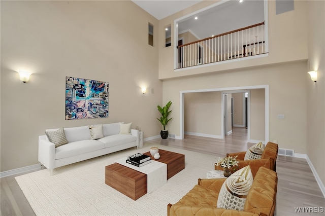 25 Davinci Ct, Amherst, NY 14221 - living room featuring a towering ceiling, baseboards, recessed lighting, and wood finished floors