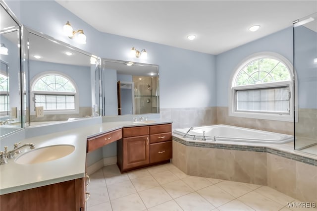 25 Davinci Ct, Amherst, NY 14221 - full bathroom with double vanity, healthy amount of natural light, a garden tub, a shower stall, and recessed lighting
