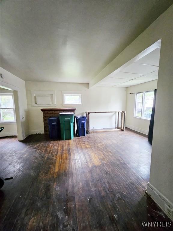 157 Victoria Ave, Buffalo, NY 14214 - unfurnished living room featuring hardwood / wood-style flooring, baseboards, and a fireplace