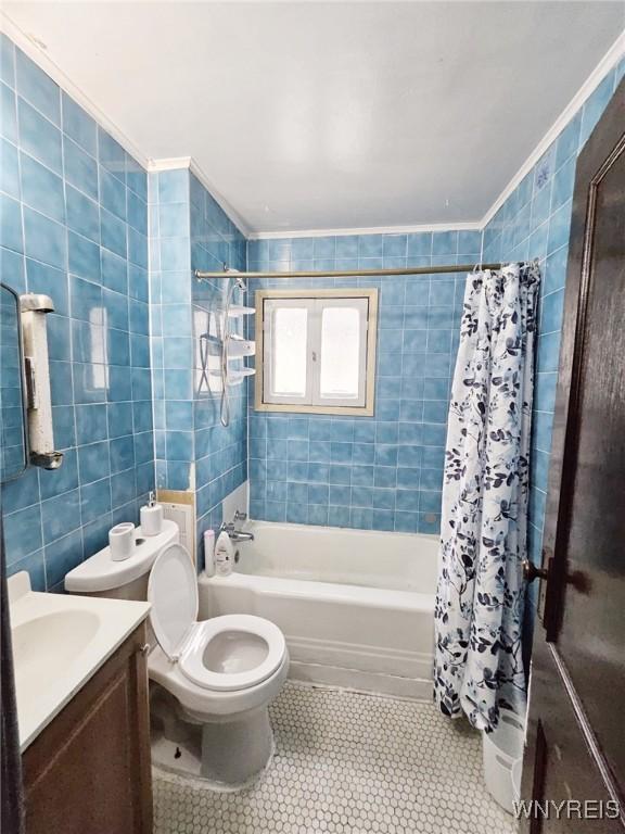 157 Victoria Ave, Buffalo, NY 14214 - bathroom featuring tile walls, shower / tub combo, tile patterned floors, vanity, and toilet