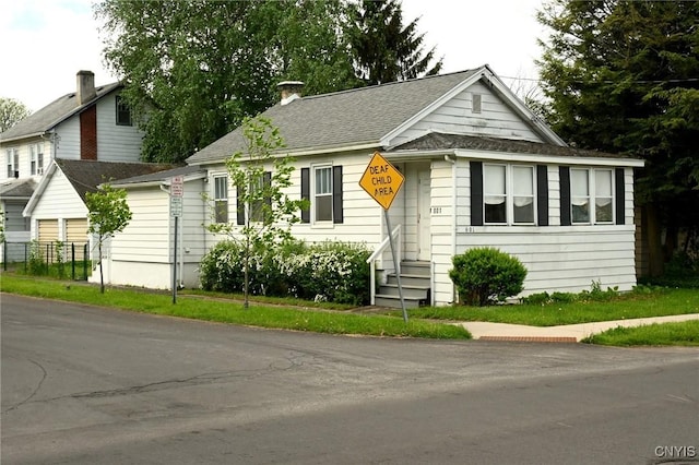 801 Ballantyne Rd, Syracuse, NY 13207 - view of front of home with entry steps, a chimney, and roof with shingles