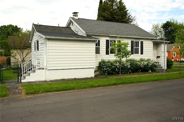 801 Ballantyne Rd, Syracuse, NY 13207 - view of home's exterior featuring a chimney and a shingled roof