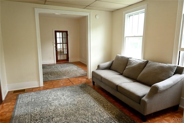 801 Ballantyne Rd, Syracuse, NY 13207 - living area with baseboards and a paneled ceiling