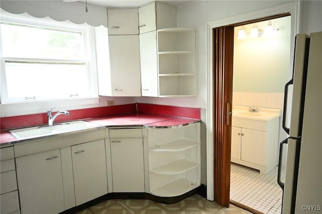 801 Ballantyne Rd, Syracuse, NY 13207 - kitchen featuring open shelves, a sink, and light countertops