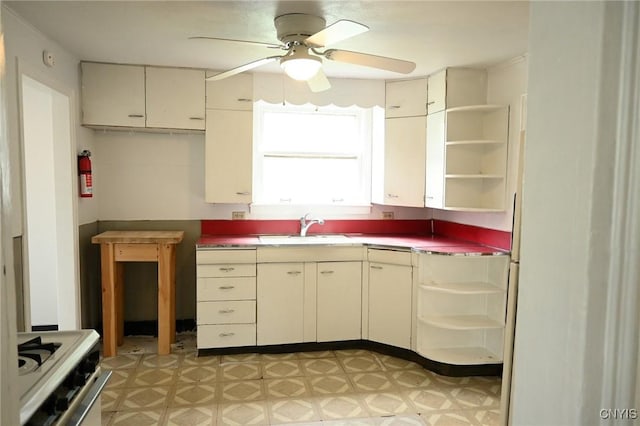801 Ballantyne Rd, Syracuse, NY 13207 - kitchen with open shelves, light floors, a sink, a ceiling fan, and white range with gas stovetop
