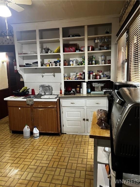 2032 Fillmore Ave, Buffalo, NY 14214 - kitchen featuring open shelves, white cabinetry, brick patterned flooring, a ceiling fan, and light countertops