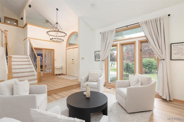 54 Contessa Ct, Amherst, NY 14221 - living room featuring wood finished floors, stairs, a chandelier, and high vaulted ceiling