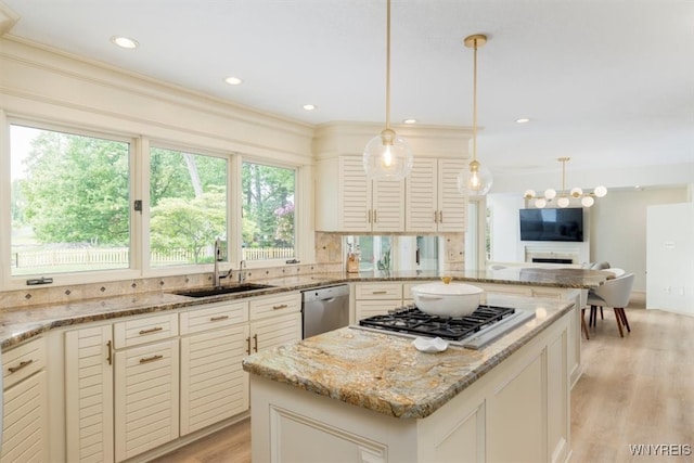 54 Contessa Ct, Amherst, NY 14221 - kitchen featuring appliances with stainless steel finishes, light stone counters, light wood-style flooring, a sink, and a center island