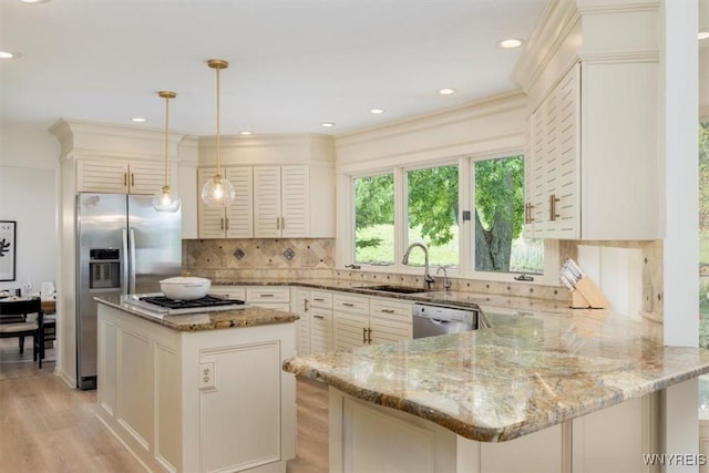 54 Contessa Ct, Amherst, NY 14221 - kitchen with stainless steel appliances, a sink, light stone counters, light wood-type flooring, and backsplash