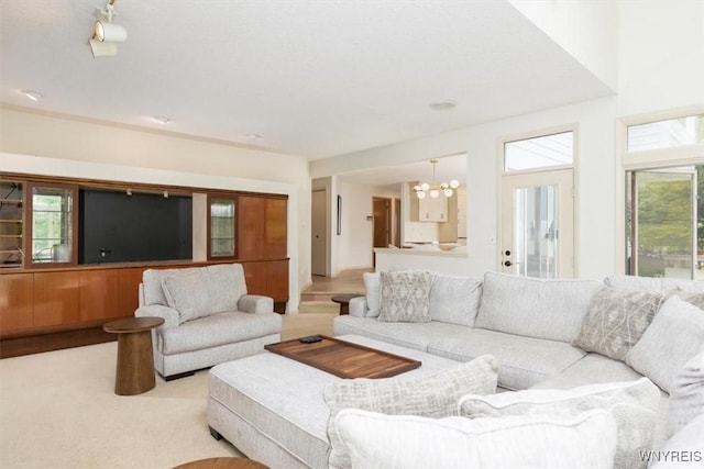 54 Contessa Ct, Amherst, NY 14221 - living room featuring a chandelier, plenty of natural light, and carpet flooring