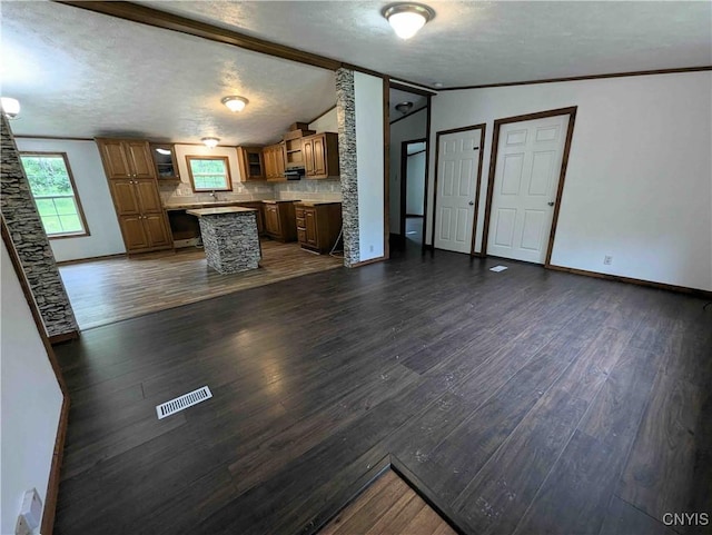 3377 Beeman Hollow Rd, Erwin, NY 14801 - unfurnished living room featuring lofted ceiling, baseboards, dark wood-style flooring, and a textured ceiling