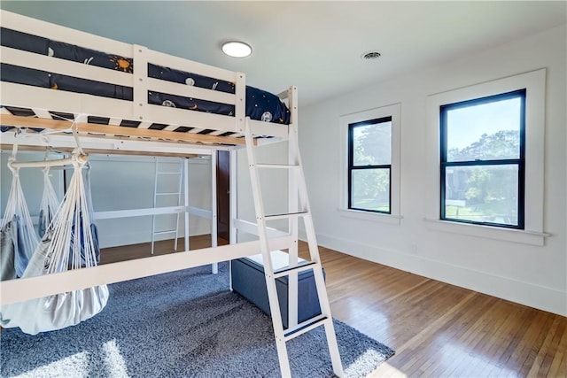 100 Eastland Ave, Brighton, NY 14618 - unfurnished bedroom with wood finished floors and baseboards