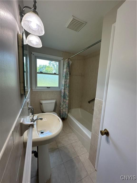 9385 Wickham Dr, Cicero, NY 13029 - bathroom with tile patterned floors, toilet, and shower / tub combo