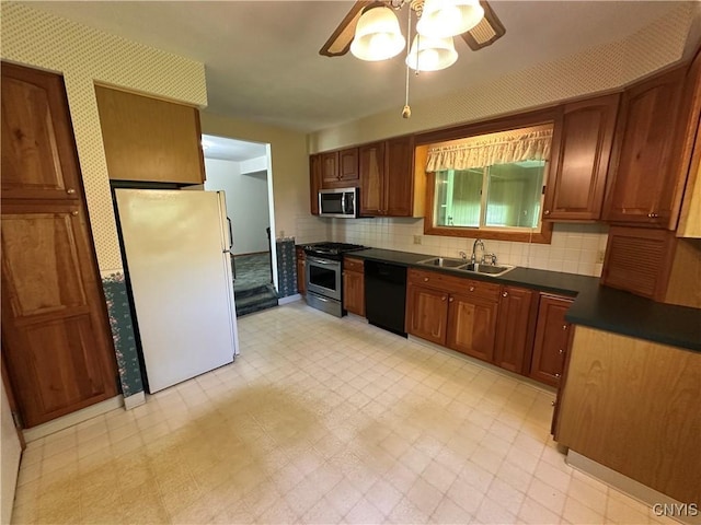 9385 Wickham Dr, Cicero, NY 13029 - kitchen featuring appliances with stainless steel finishes, a sink, dark countertops, a ceiling fan, and light floors