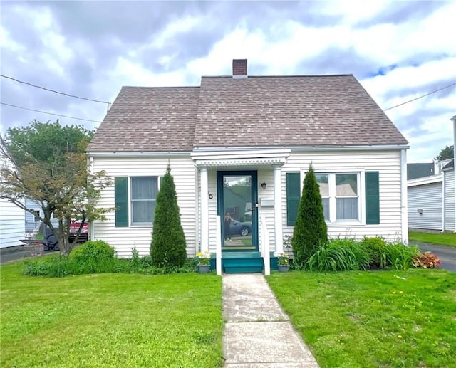 305 S Hoffman St, Elmira-City, NY 14904 - cape cod house featuring roof with shingles, a front lawn, and a chimney