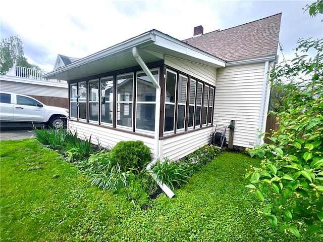 305 S Hoffman St, Elmira-City, NY 14904 - view of property exterior featuring a shingled roof, a sunroom, and a chimney