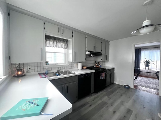 305 S Hoffman St, Elmira-City, NY 14904 - kitchen featuring under cabinet range hood, a sink, black appliances, and backsplash