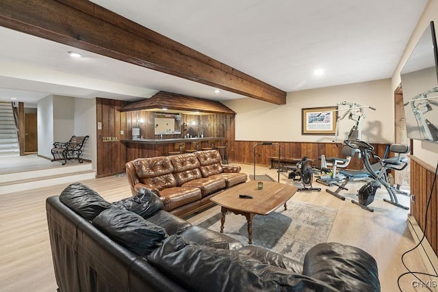 4962 Tall Oaks Dr, Manlius, NY 13066 - living room featuring a wainscoted wall, wooden walls, wood finished floors, stairs, and beam ceiling