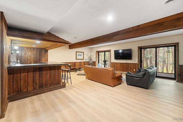 4962 Tall Oaks Dr, Manlius, NY 13066 - living room featuring bar area, wood walls, wood finished floors, wainscoting, and beamed ceiling