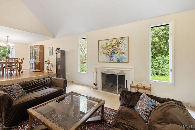 4962 Tall Oaks Dr, Manlius, NY 13066 - living area featuring healthy amount of natural light, a fireplace with flush hearth, a chandelier, and lofted ceiling