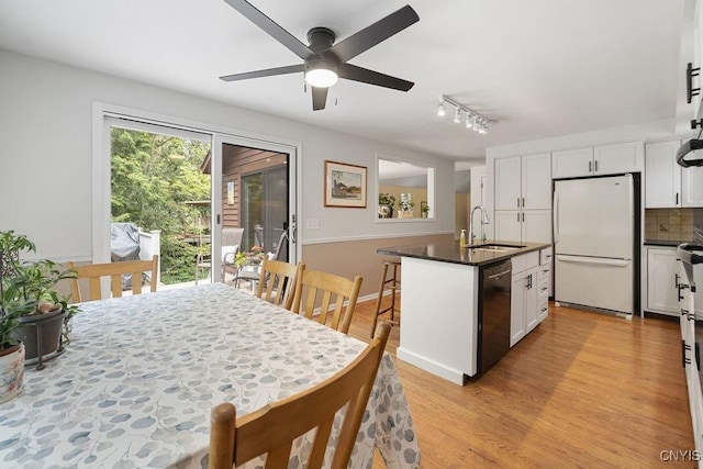 4962 Tall Oaks Dr, Manlius, NY 13066 - kitchen with freestanding refrigerator, black dishwasher, dark countertops, ceiling fan, and white cabinets