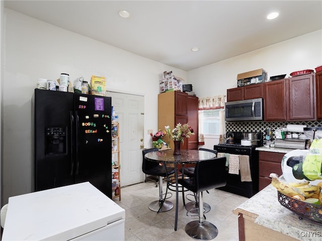 416 Gotham St, Watertown-City, NY 13601 - kitchen with stainless steel microwave, black fridge, range, light countertops, and recessed lighting