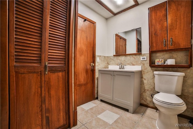 421 E Utica St, Buffalo, NY 14208 - half bathroom featuring vanity, toilet, tile patterned floors, and tile walls