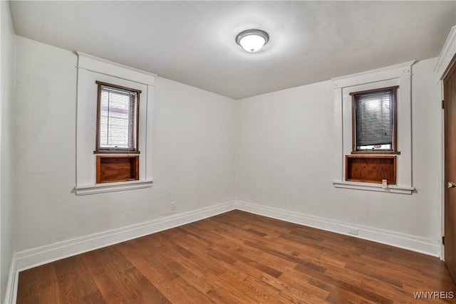 421 E Utica St, Buffalo, NY 14208 - unfurnished room featuring baseboards and dark wood-type flooring