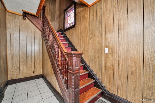421 E Utica St, Buffalo, NY 14208 - stairs with wooden walls, tile patterned flooring, and baseboards