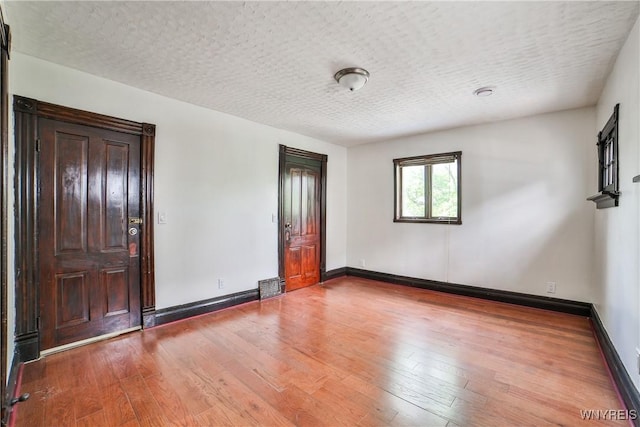 421 E Utica St, Buffalo, NY 14208 - unfurnished bedroom with hardwood / wood-style flooring, baseboards, and a textured ceiling