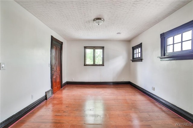 421 E Utica St, Buffalo, NY 14208 - unfurnished room with a textured ceiling, wood finished floors, and baseboards