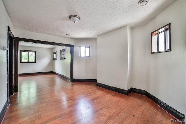 421 E Utica St, Buffalo, NY 14208 - spare room with plenty of natural light, wood finished floors, baseboards, and a textured ceiling