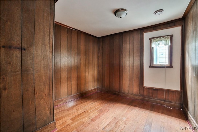 421 E Utica St, Buffalo, NY 14208 - unfurnished room with light wood finished floors, wood walls, and baseboards