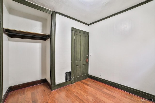 421 E Utica St, Buffalo, NY 14208 - unfurnished bedroom featuring baseboards, wood finished floors, and crown molding