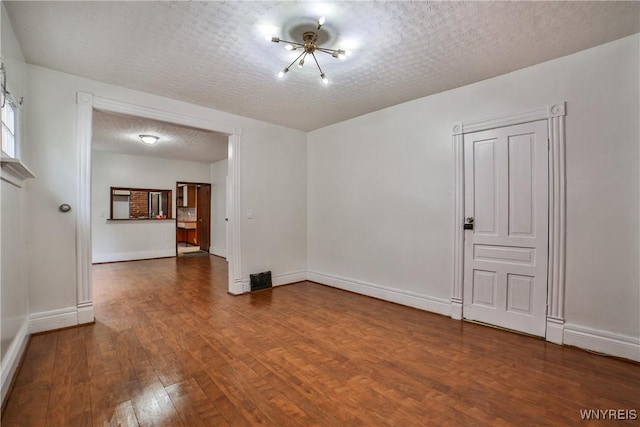 421 E Utica St, Buffalo, NY 14208 - empty room with wood finished floors, baseboards, and a textured ceiling