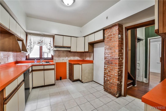 421 E Utica St, Buffalo, NY 14208 - kitchen featuring a sink, black dishwasher, decorative backsplash, and white cabinetry