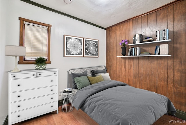 421 E Utica St, Buffalo, NY 14208 - bedroom with crown molding, wood walls, and wood finished floors