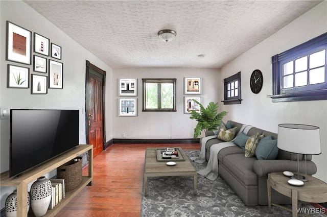 421 E Utica St, Buffalo, NY 14208 - living area with wood finished floors, a textured ceiling, and baseboards
