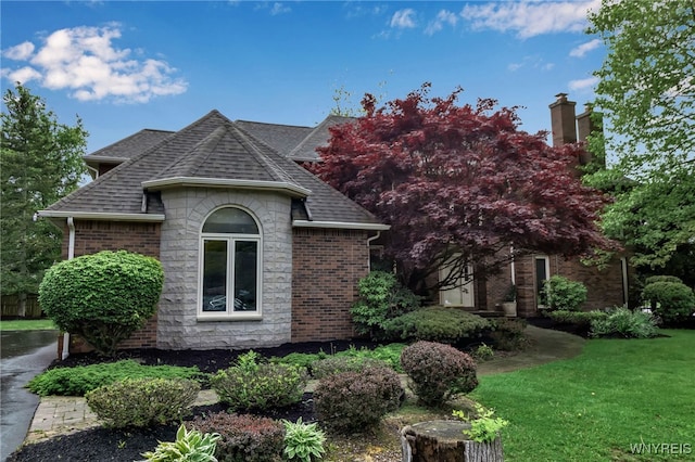 8395 Black Walnut Dr, Clarence, NY 14051 - view of home's exterior featuring brick siding, a shingled roof, a chimney, and a lawn