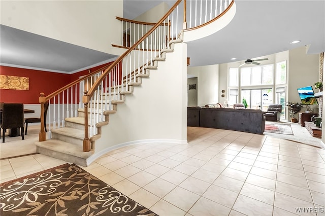 8395 Black Walnut Dr, Clarence, NY 14051 - stairs featuring a towering ceiling, ceiling fan, and tile patterned floors