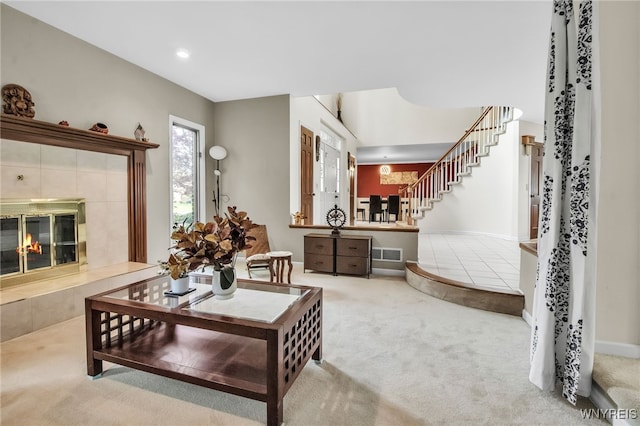 8395 Black Walnut Dr, Clarence, NY 14051 - living room with carpet floors, a tile fireplace, stairway, recessed lighting, and baseboards
