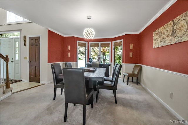 8395 Black Walnut Dr, Clarence, NY 14051 - dining space featuring carpet floors, baseboards, stairs, and crown molding