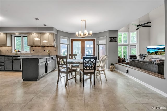 8395 Black Walnut Dr, Clarence, NY 14051 - dining area with baseboards, ceiling fan, light tile patterned floors, and a chandelier