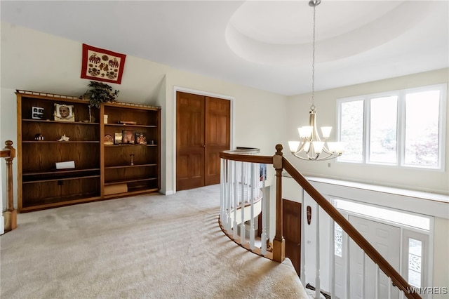 8395 Black Walnut Dr, Clarence, NY 14051 - corridor featuring a chandelier, an upstairs landing, and light colored carpet