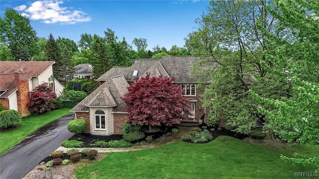 8395 Black Walnut Dr, Clarence, NY 14051 - view of front facade with a front lawn, brick siding, and driveway