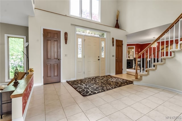 8395 Black Walnut Dr, Clarence, NY 14051 - tiled foyer entrance with a high ceiling, stairs, and baseboards