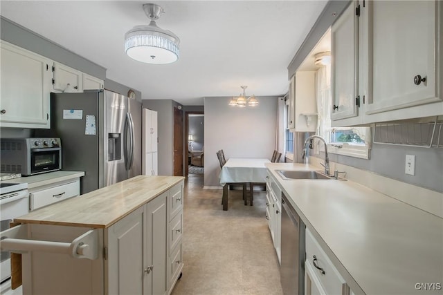 8013 Plinius, Clay, NY 13090 - kitchen featuring a sink, butcher block counters, appliances with stainless steel finishes, a center island, and a chandelier