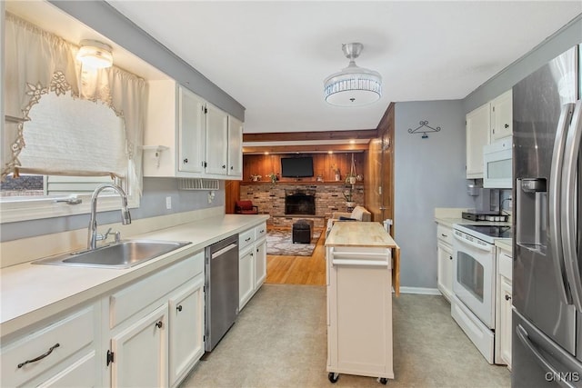 8013 Plinius, Clay, NY 13090 - kitchen with stainless steel appliances, a sink, light countertops, and white cabinets